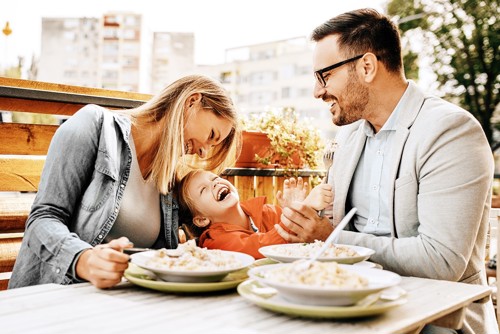 family out eating meal